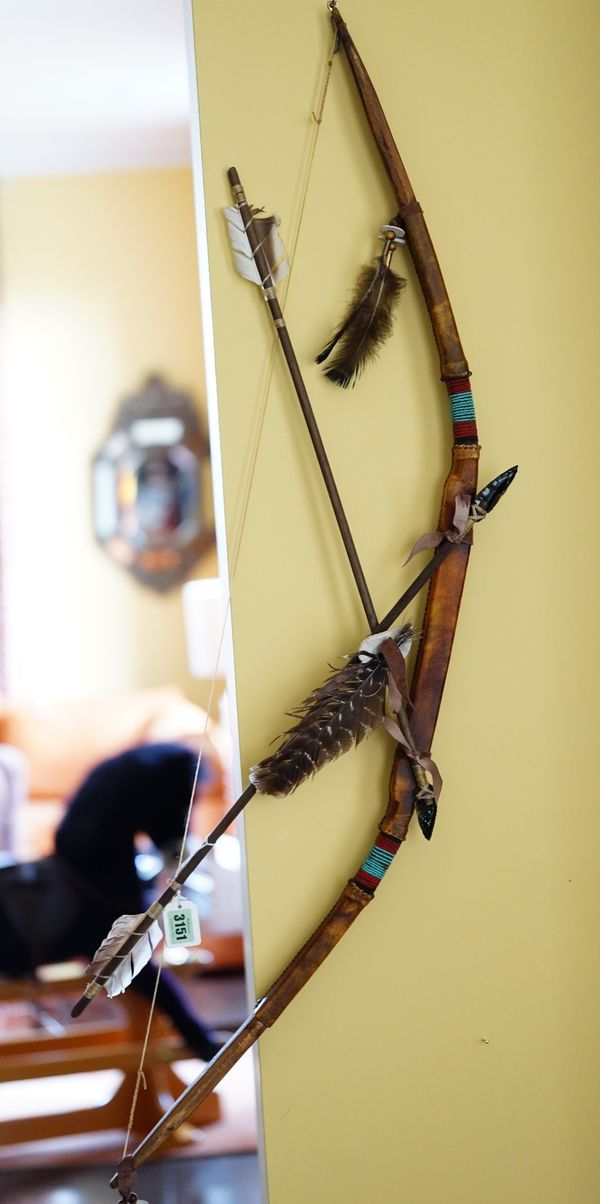 A North American leather covered bow with bead-work band and two arrows (3).112cm long x 22cm wide