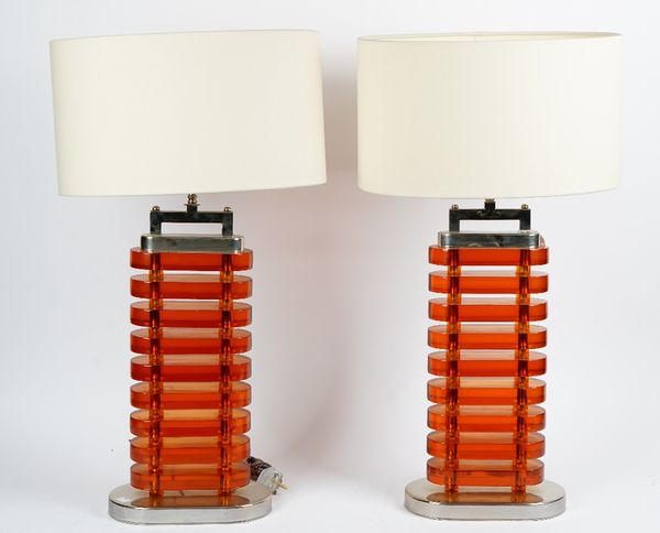 A pair of amber perspex and nickel plated table lamps, circa 1960, of oval form, in Art Deco style.*** Originally in a hotel in Berlin81cm high