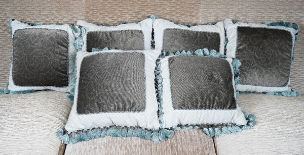 A group of six cushions with tassel borders (6).