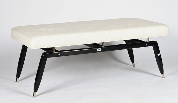 An ebonised bench, with splayed legs and white button-down linen seat, 127cm wide x 49cm high.