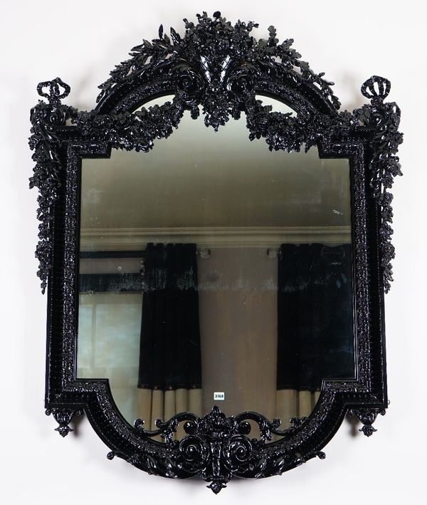 An ornate high black gloss frame mirror, in 19th century French style, with ribbon tied foliate ornament, 120cm wide x 150cm high.