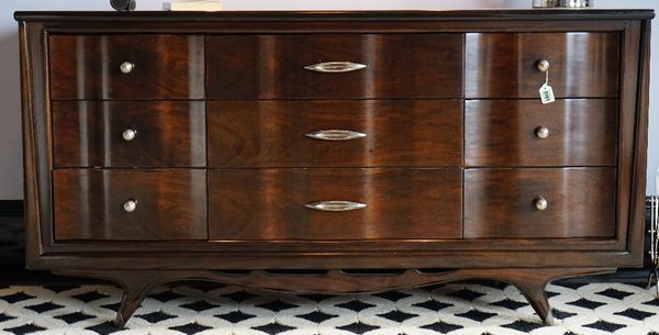 A Kent Coffey, The Appleton walnut chest, the nine drawers with wavy fronts, 163cm wide x 85cm high.