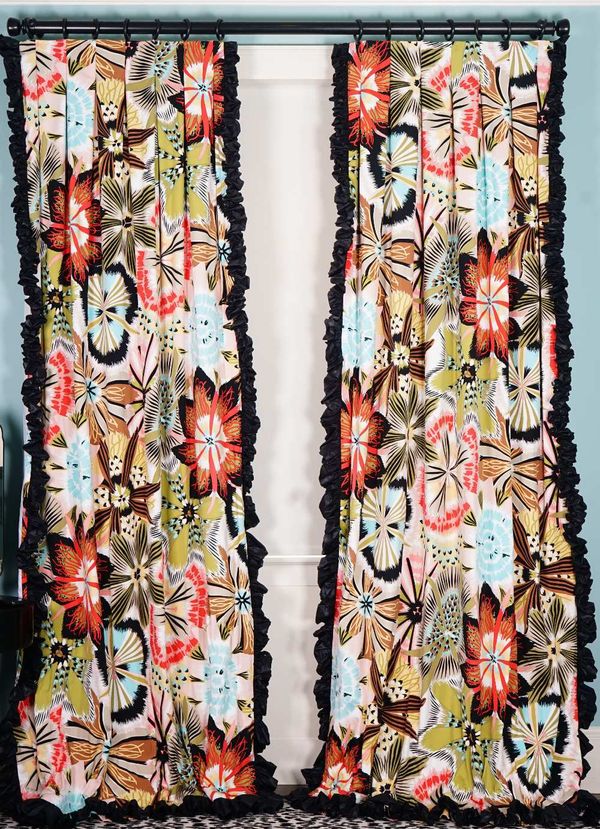 A pair of curtains, with large multicoloured wild flower pattern, with ruched black chintz trim. 180cm wide x 300cm long.