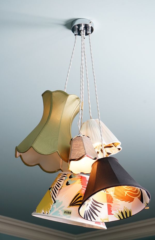 A pendant light fitting composed of five varying lamp shades.