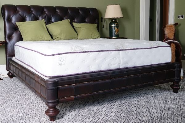 A King size Chesterfield bed, button-down upholstered in chocolate brown leather, 208cm wide x 144 high, with a Beautyrest mattress.