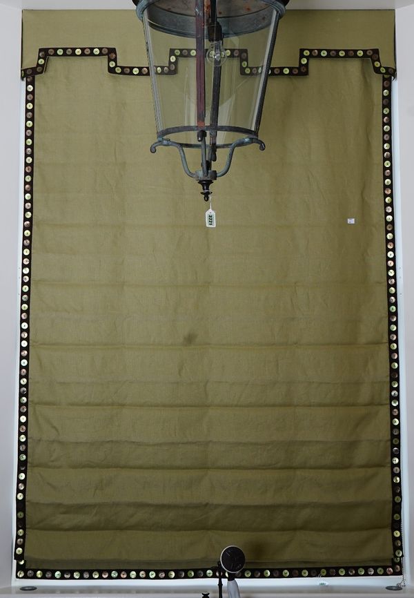 A Roman blind, in green linen with button border.135cm wide x 210cm long