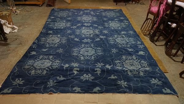 A Chinese carpet, with repeated floral designs, on a blue ground, 378cm x 242cm.