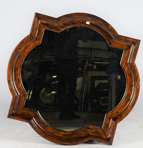 A shaped wall mirror, in moulded frame, 92cm wide x 91cm high.