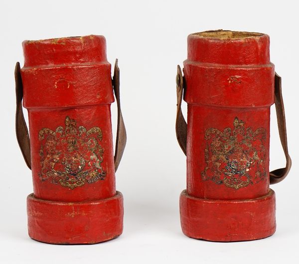 Two red painted canvas cartridge cases with leather swing handles and Royal crests, 33.5cm high, (2).