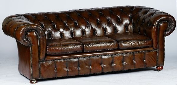 A Victorian style Chesterfield settee, button-down upholstered in brown leather, with loose seat cushions, 217cm wide x 74cm high.