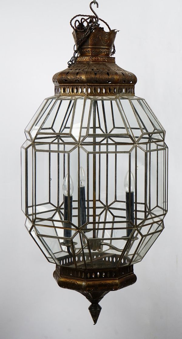 A silvered metal octagonal hanging lantern of three lights in a Moorish style, with glazed sides, 45cm wide x 100cm high.