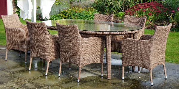 Expormim; a wicker woven garden table with oval plate glass top and a set of six matching elbow chairs (7).63cm wide x 86cm high