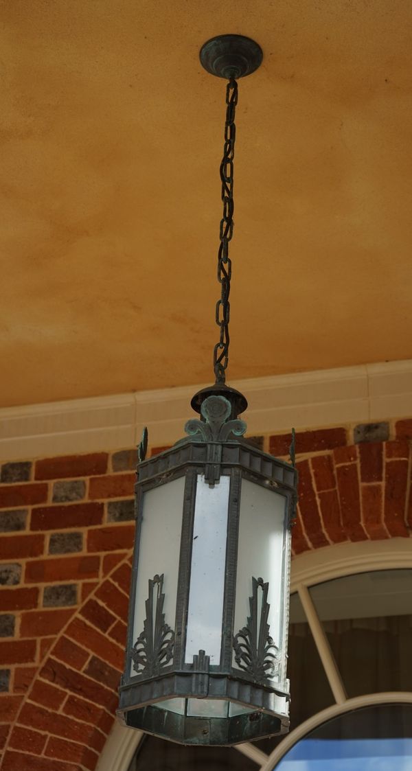 An octagonal lantern, the bronzed frame with opaque glass panels, 65cm high x 24cm wide.