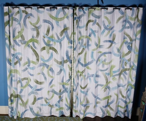 A pair of printed linen curtains, in abstract design. 250cm wide x 305cm long.