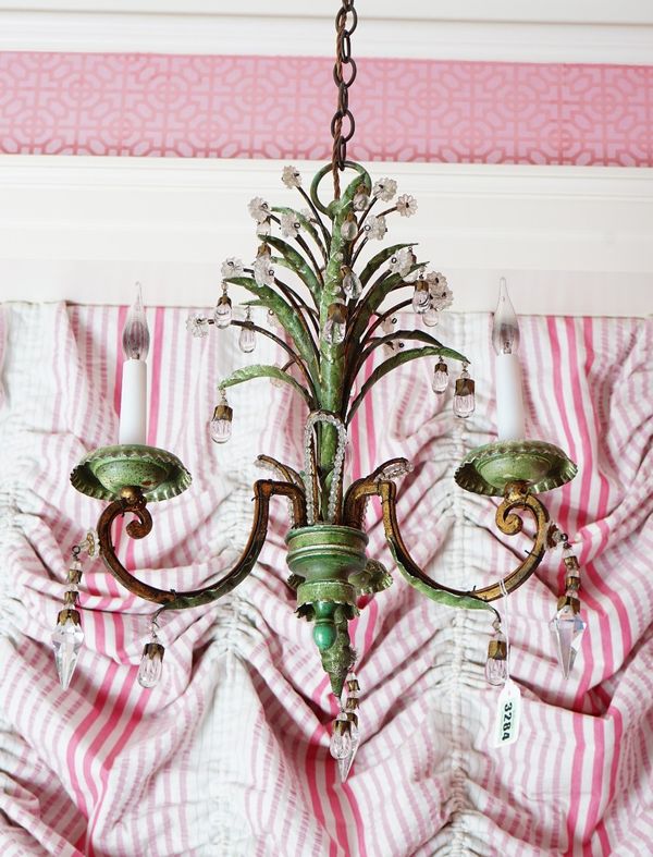 A three light chandelier, the gilt metal and green patinated frame hung with glass drops and surmounted by curved leaves, 44cm high