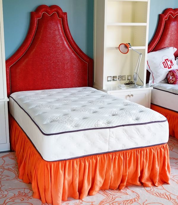 A pair of divan beds, by Beautyrest, with shaped close moulded red faux lizard skin headboards, 143cm wide x 195cm high, each with a Beautyrest mattre