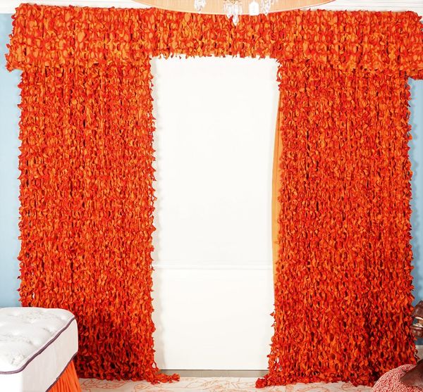 A pair of shredded burnt orange silk curtains, backed with linen curtains. 110cm wide x 285cm long. (Pelmets not included)