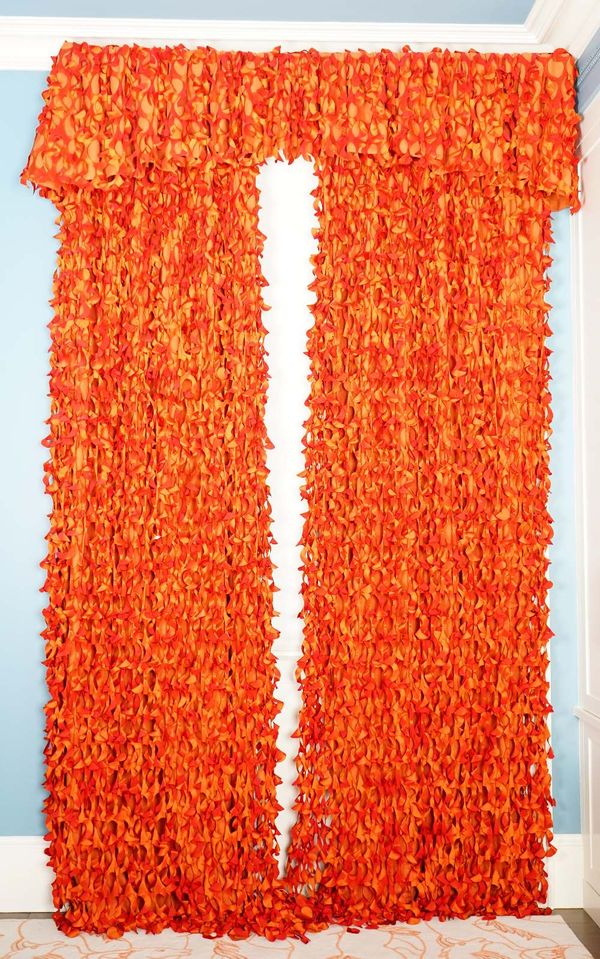 A pair of shredded burnt orange silk curtains, backed with linen curtains. 85cm wide x 280cm long, (Pelmets not included).