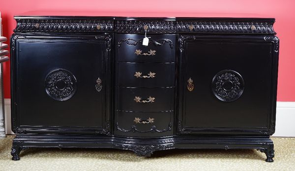 A black lacquered dresser, in period style, with four bowfronted drawers to the centre, three shallow frieze drawers and six further drawers enclosed