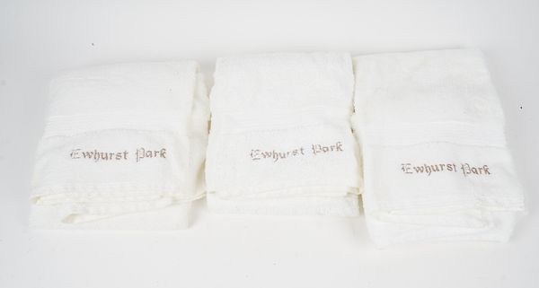 A collection of white towels in various sizes, each inscribed 'Ewhurst Park' (qty).