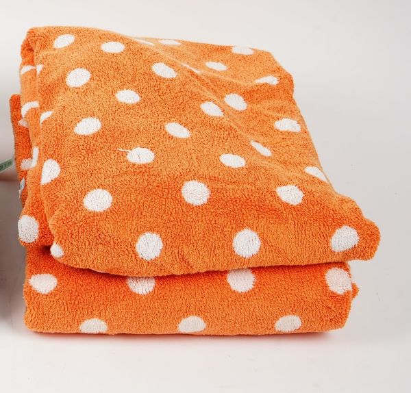 A collection of orange and white spotted towels (qty).