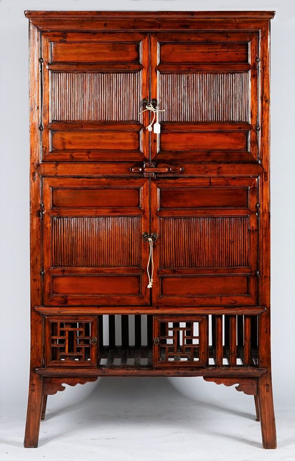 An Asian cabinet, enclosed by two pairs of doors with a compartment below enclosed by sliding doors, 111cm wide x 195cm high.