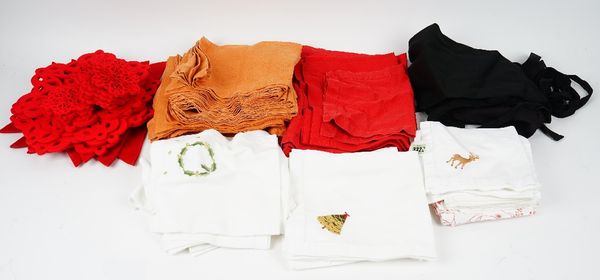 A set of white cotton napkins, embroidered with deer and other napkins and mats, some with christmas theme and four black aprons (qty).