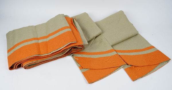 A set of three green linen tablecloths, bordered in orange.