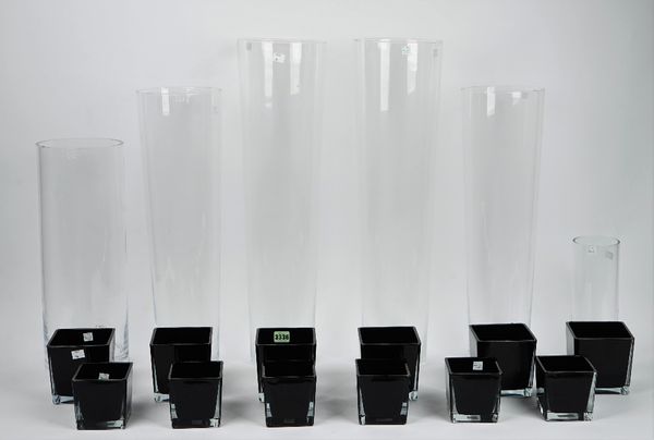 Two sets of six square tapering black glass vases, in two graduated sizes, a lacquer ware planter containing artificial flowers, two pairs of tall gla