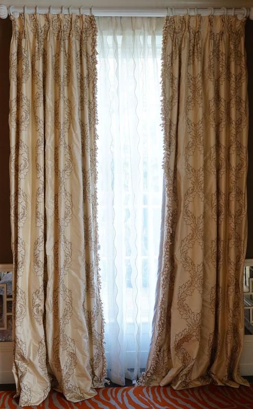 A pair of acanthus pattern cream silk curtains with onion tassel fringes. 85cm wide x 310cm long.