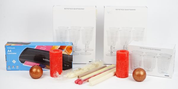 A large collection of assorted candles, boxed drinking glasses, flower holder, A4 laminator, two electric pencil sharpeners and other items (qty).