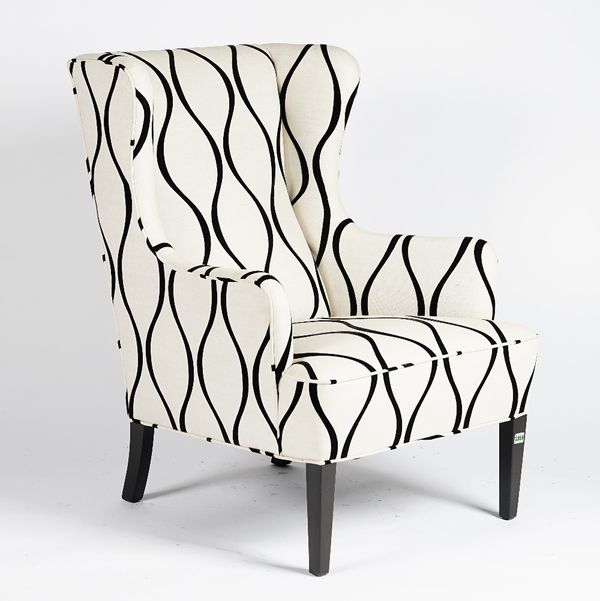 A mid century wing armchair, upholstered in ivory and black geometric linen, with black lacquered legs, 72cm wide x 98cm high.