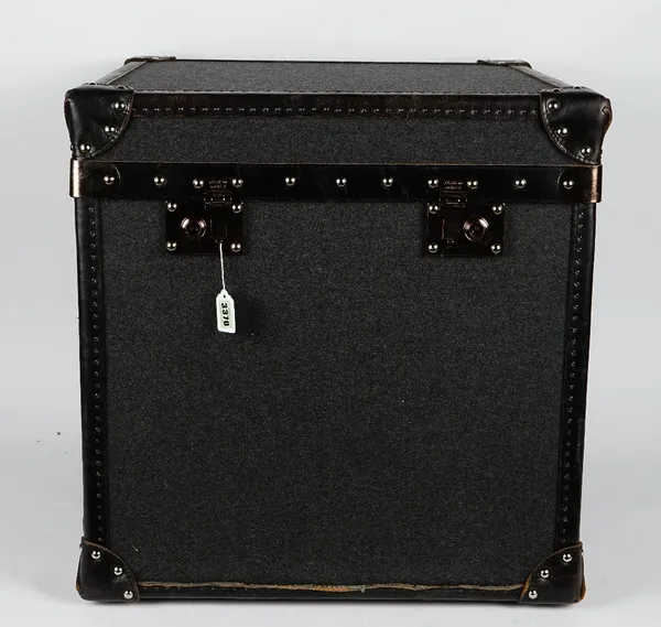 A grey felt covered square trunk, by Andrew Martin, with black and brown studded leather banding and hinged top, 58cm wide x 61cm high.
