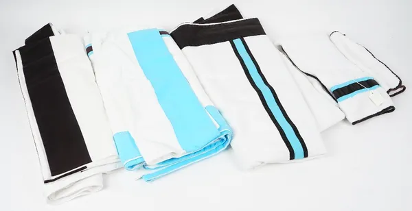 A set of matching towels, flannels and bed linen, white with blue trim.