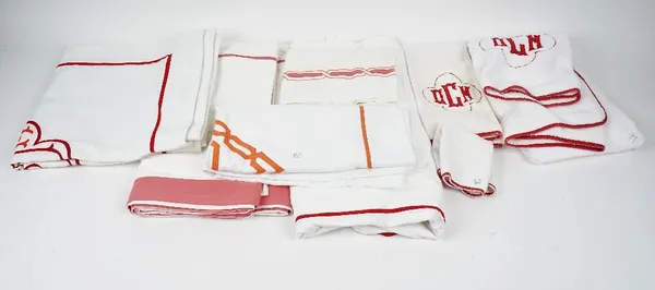 A set of matching towels, flannels and bed linen, white with red trim and initials 'DCM', and other linen.