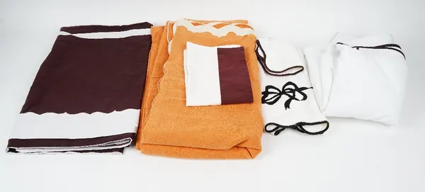 A set of matching towels, flannels and bed linen, white with dark purple trim.