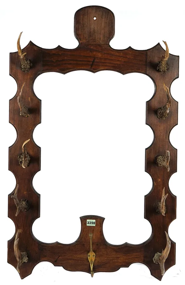 An Antler mounted coat rack, of shaped rectangular form, 62cm wide x 100cm high.