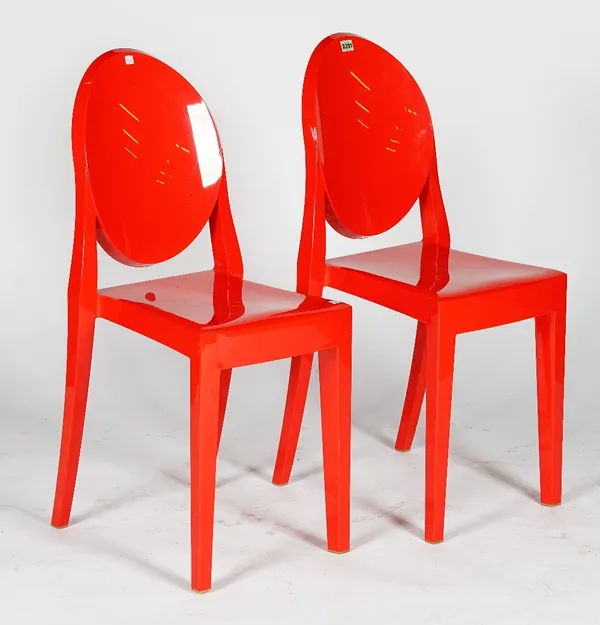 A pair of red chairs, Victoria Ghost design S+ARCK by Kartell, 39cm wide x 91cm high, (2).