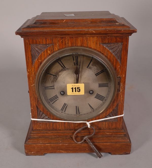 An early 20th century oak cased mantel clock with silvered dial and an eight day movement, 22cm wide x 28cm high. S1T