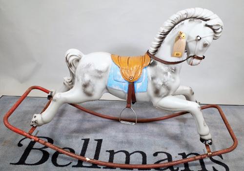 A 20th century fibre glass rocking horse on metal base, 125cm wide x 86cm high.   C3
