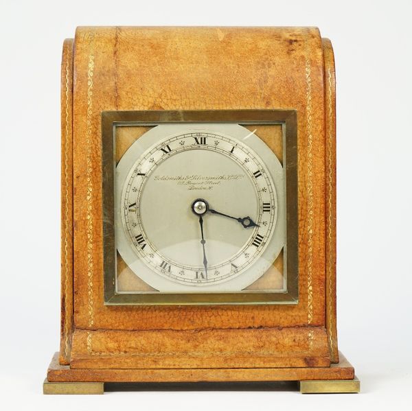 An Edwardian leather desk timepiece  Retailed by the Goldsmiths & Silversmiths, London, by Elliott    The tan leather veneered case with gilt tooling,