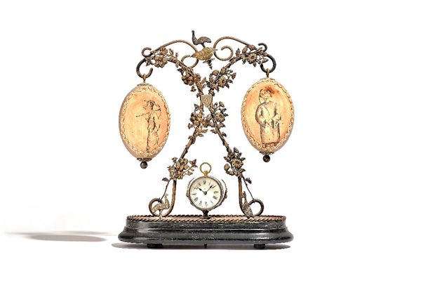 Australian interest; three late 19th/ early 20th century watch holders, each with ostrich egg finial over a watch stand and ebonised oval wooden base,