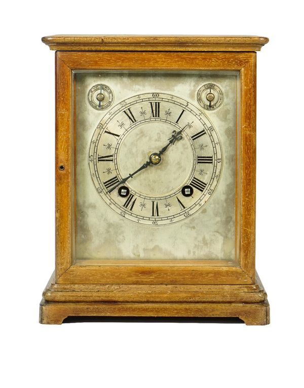 An early 20th century mahogany cased mantel clock, with silvered plate and twin subsidiary dials detailed slow/fast and chime/silent, the glazed case