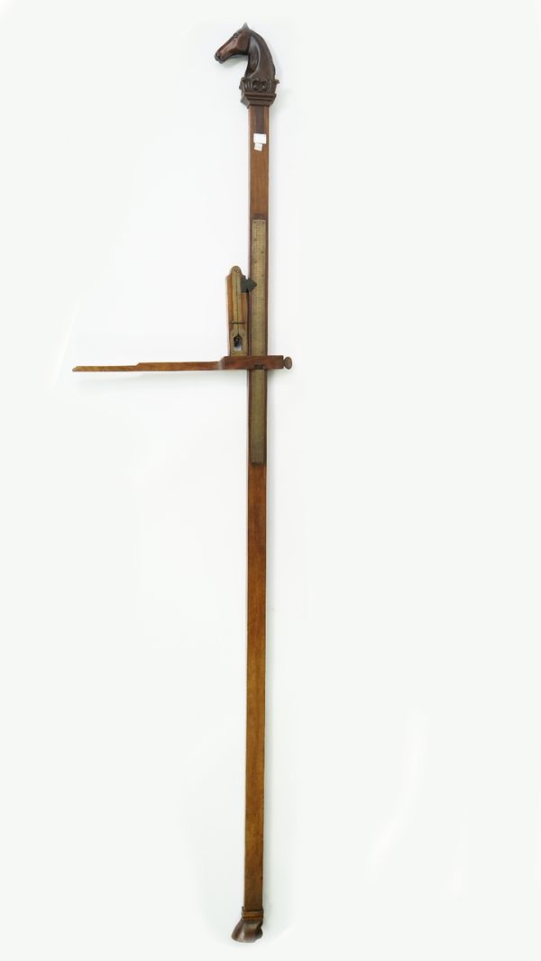 A mahogany and brass inlaid horse measuring stick, with carved horses head finial and hoof base, 230cm high.