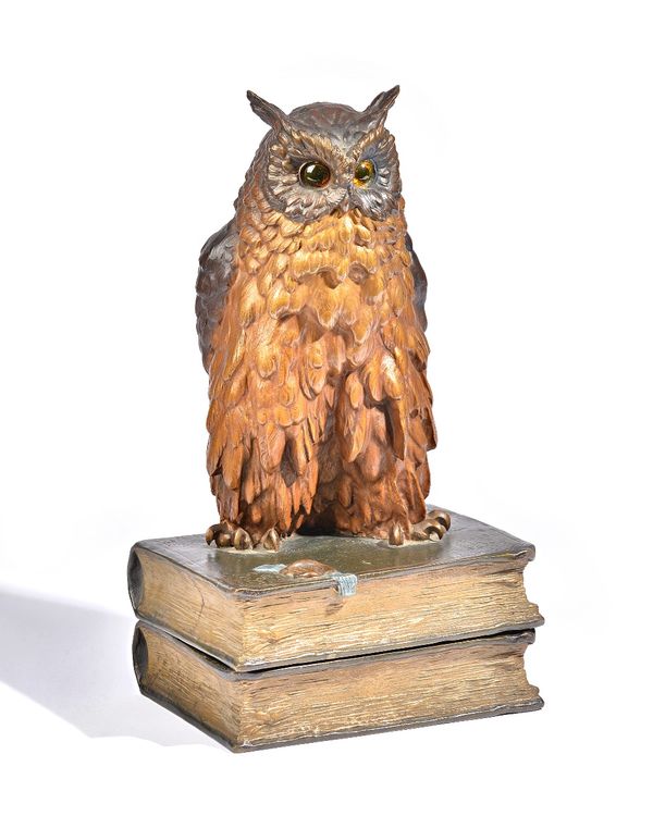 A cold painted bronze owl, 20th century, modelled on two books with faux wax seal incised 'BERMANN WIEN', 41cm high overall.