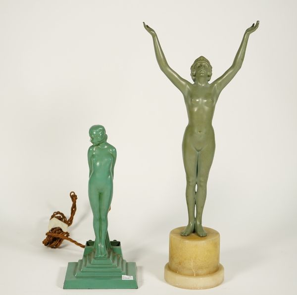 An Art Deco figural table lamp, verdigris patinated metal, depicting a female nude on a stepped rectangular base, 26cm high, and an Art Deco female nu