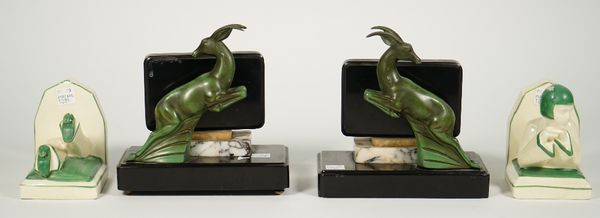 A pair of Art Deco book ends, each modelled with a verdigris patinated leaping gazelle on a stepped marble plinth, 17cm high, and a pair of pottery fi