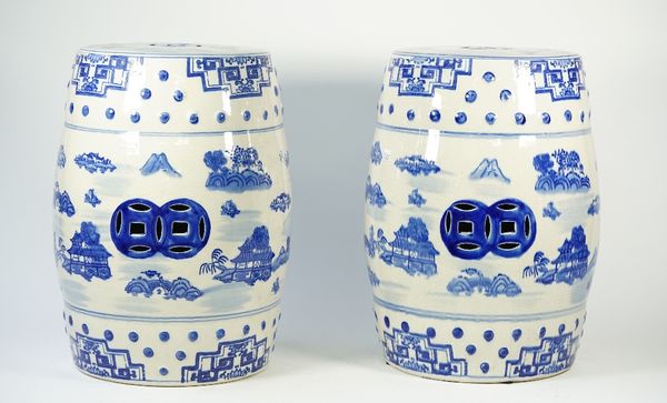 A pair of modern Chinese style blue and white porcelain garden seats, each decorated with landscape scenes against a pierced barrel form ground, 46cm