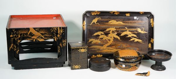 A collection of Asian lacquer wares, mainly 20th century, including; a Japanese low table, gilt decorated with cranes amongst prunus, 54cm wide, a set