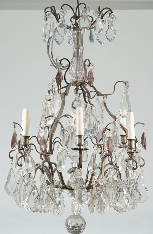 A Victorian style metal and glass mounted six light chandelier hung with shaped clear and amethyst coloured glass drops over a graduated frame, 75cm h